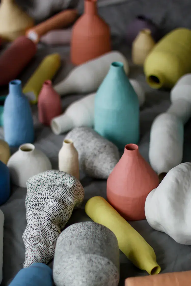Group of miniature porcelain forms on a shelf