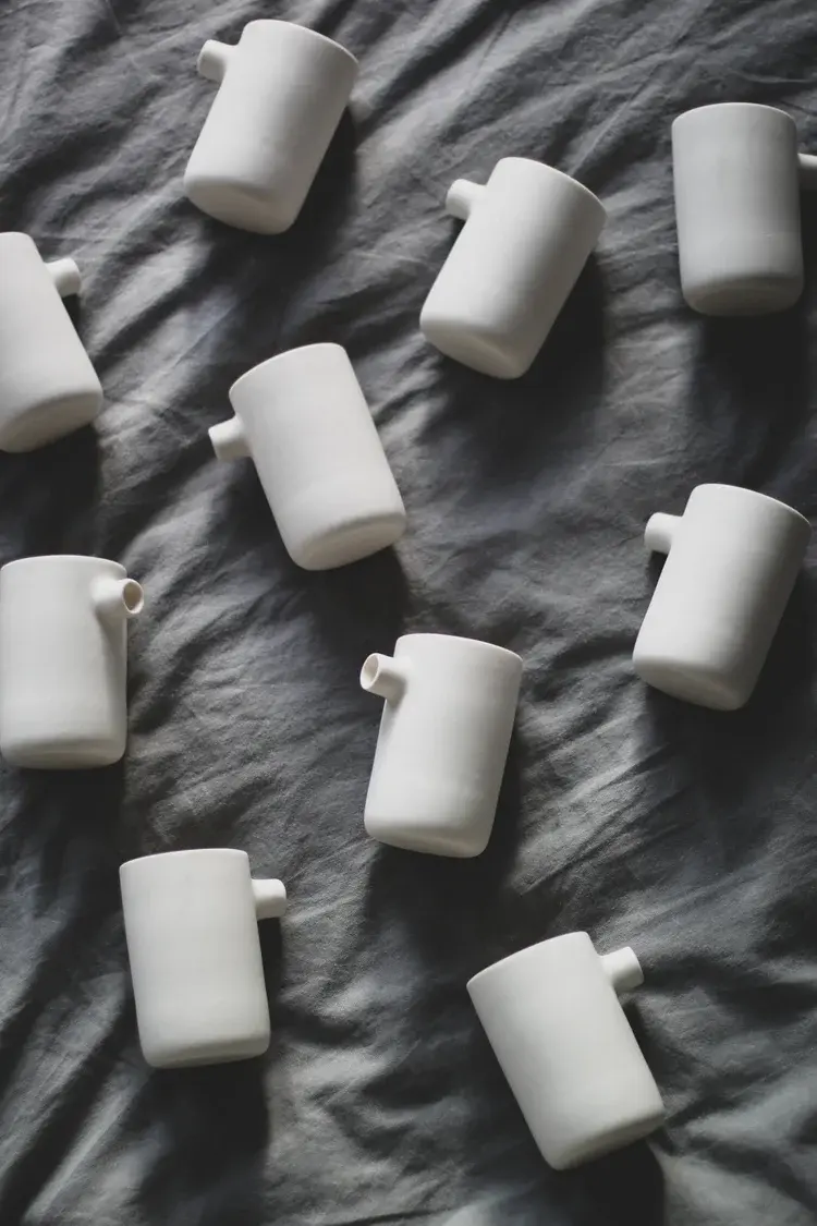 Pouring liquid clay slip into plaster mould