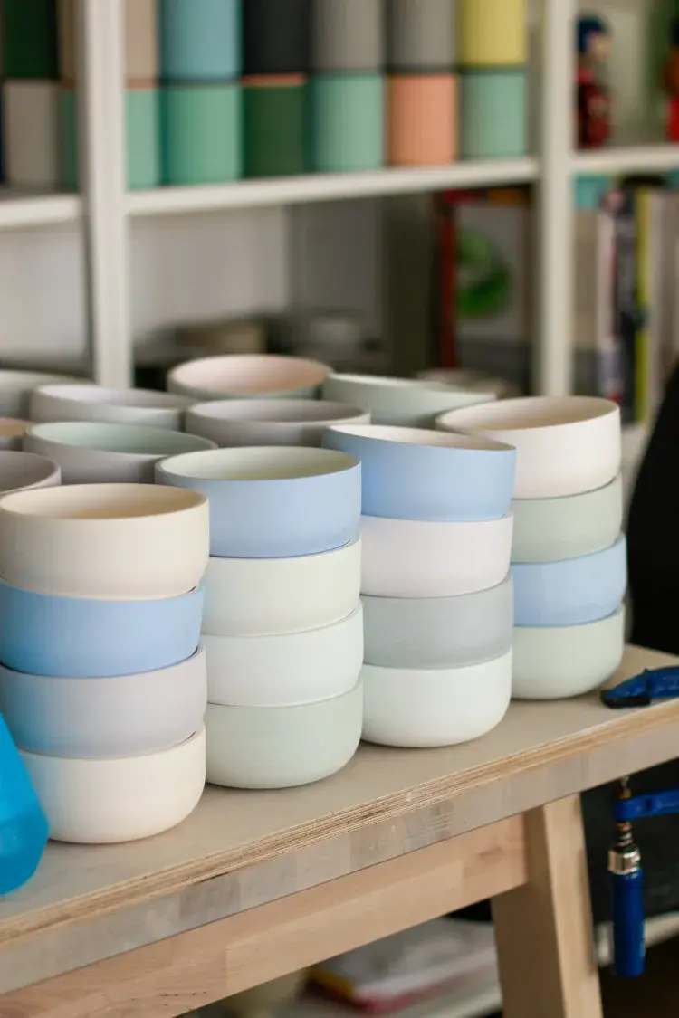 Slip-cast porcelain vessels displayed on linen cloth