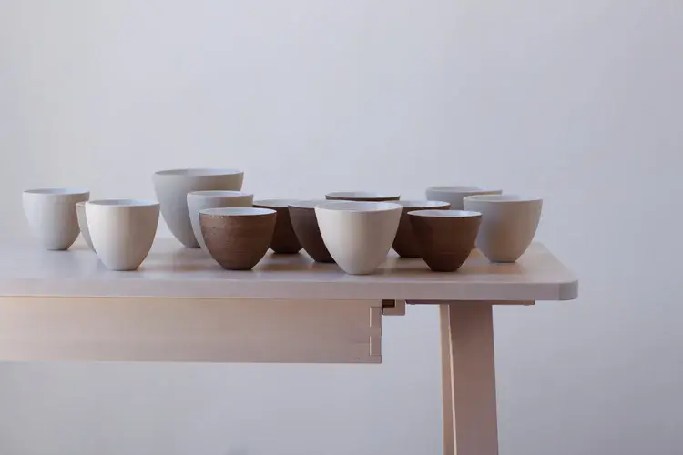 Stoneware jug with hand-formed spout and coiled body