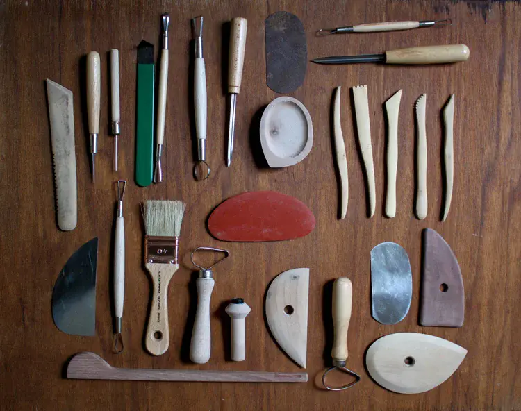Clay tools and brushes arranged on work table