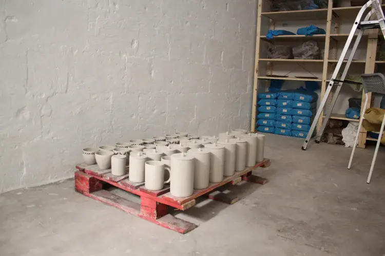 Glazed ceramics cooling on studio shelf after firing